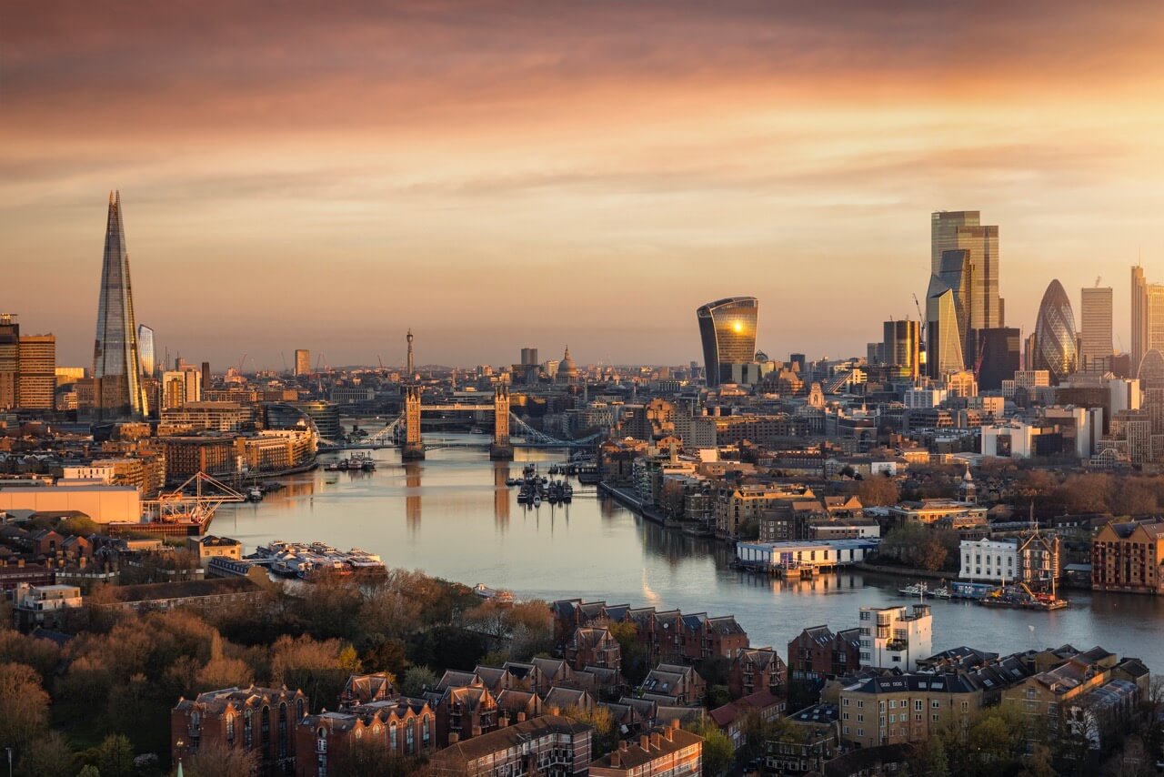 Panoramic, aerial view to the urban skyline of London during a golden sunrise