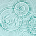 Blue water texture, blue mint water surface with rings and ripples.