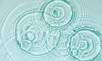 Blue water texture, blue mint water surface with rings and ripples.