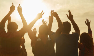 People celebrating victory, hands up.